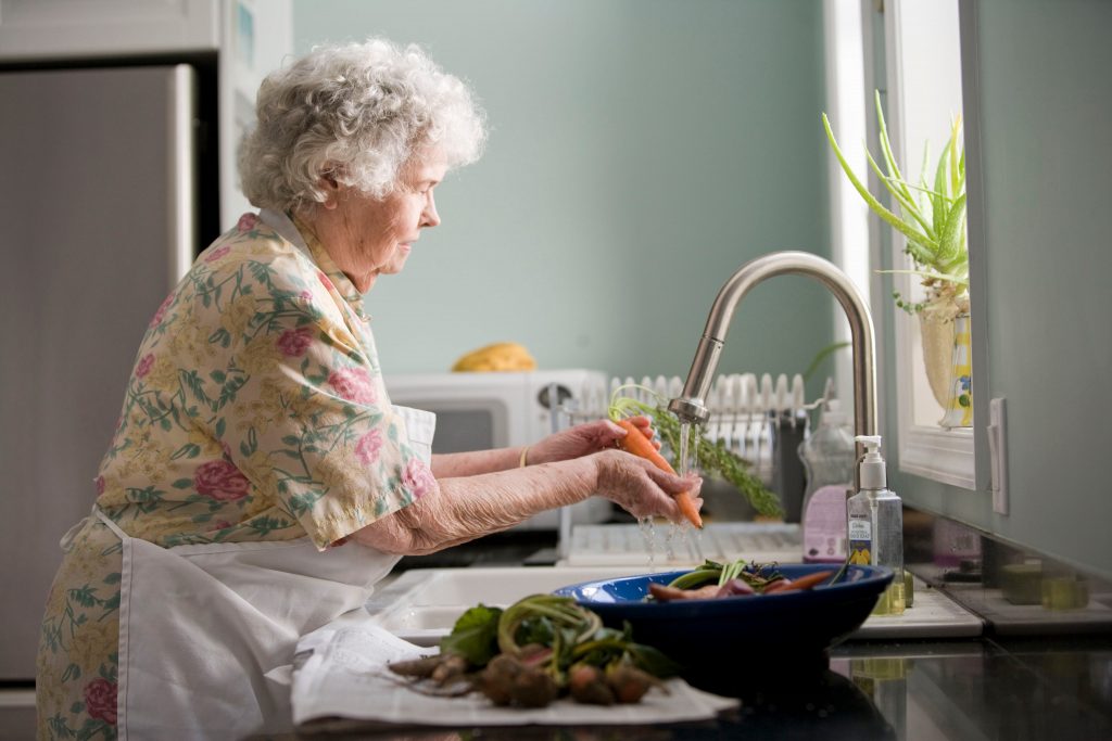 Elderly washing vegetables