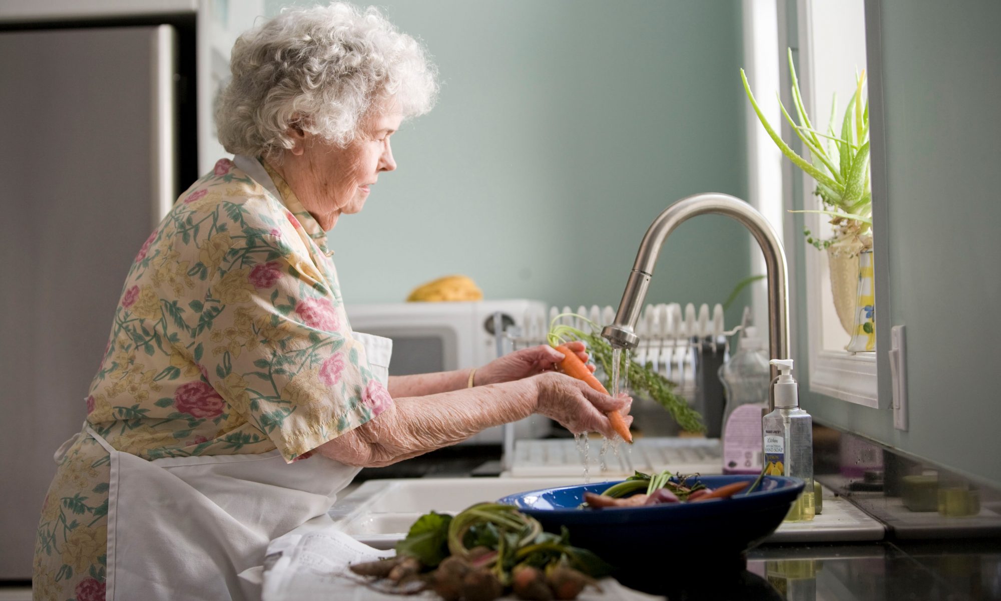 Elderly washing vegetables